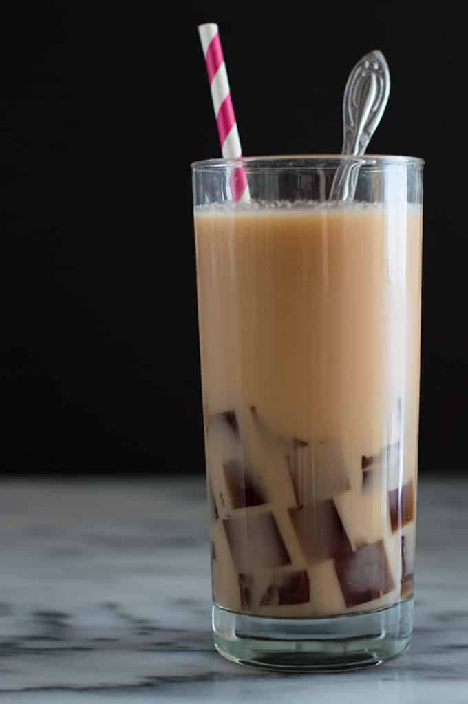 Milk tea and coffee jelly in a glass.