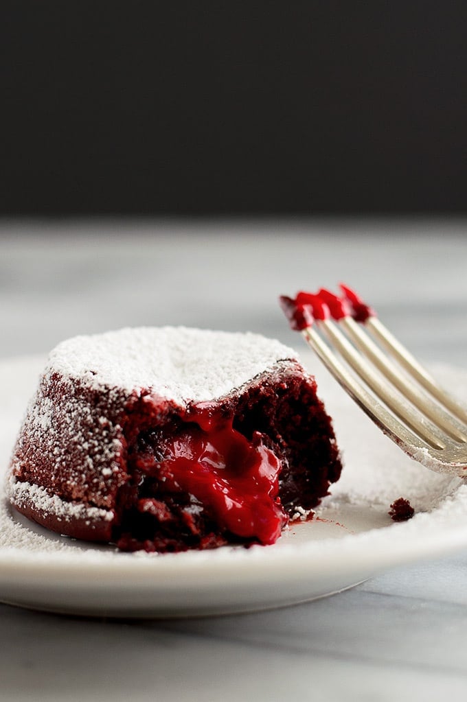 Red velvet lava cake with bite taken out.