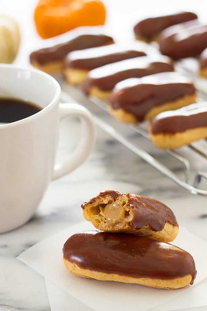 Pumpkin eclairs and a cup of coffee.