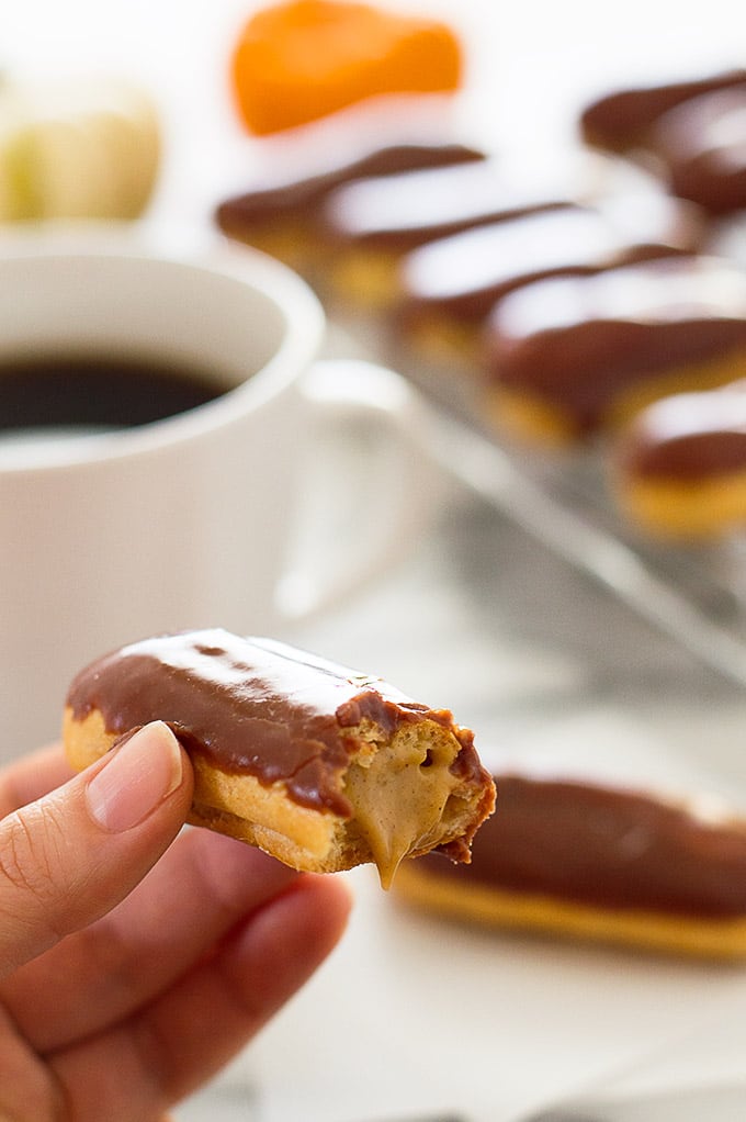 Pumpkin eclair with a bite taken out of it.