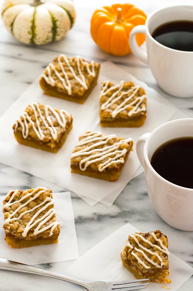 Pumpkin pie bars slices on parchment paper.