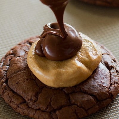Buckeye brownie cookie being drizzled with chocolate.