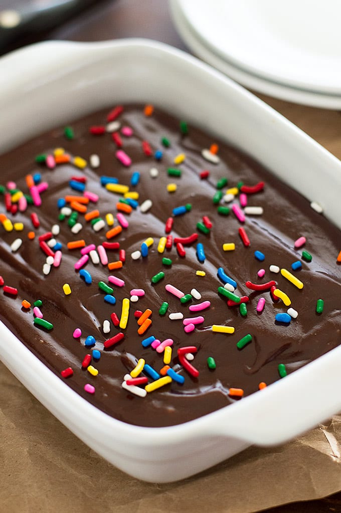 Picture of mini chocolate sheet cake in a white dish with sprinkles.