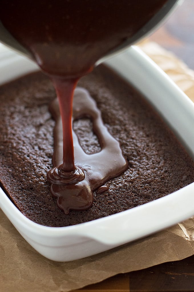 Photo of chocolate icing being poured over mini chocolate sheet cake.