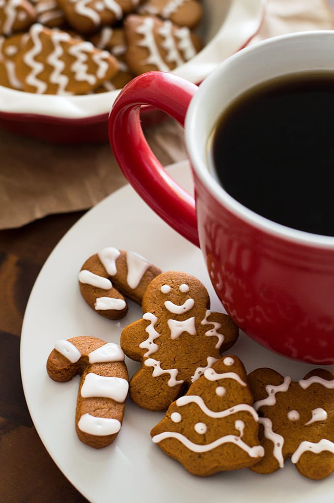 Small batch of gingerbread cookies on a plate with coffee.
