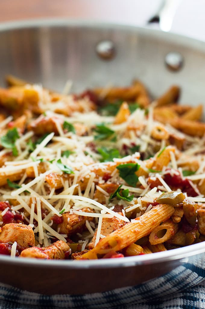 Easy Pasta Primavera with sweet crunchy bell peppers, tomatoes, and lean chicken breast served over penne pasta and topped with Parmesan cheese. From BakingMischief.com