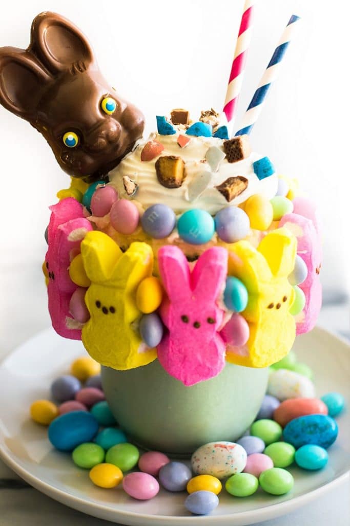 Picture of an Easter Candy Freakshake in a mason jar with a chocolate bunny head on top.