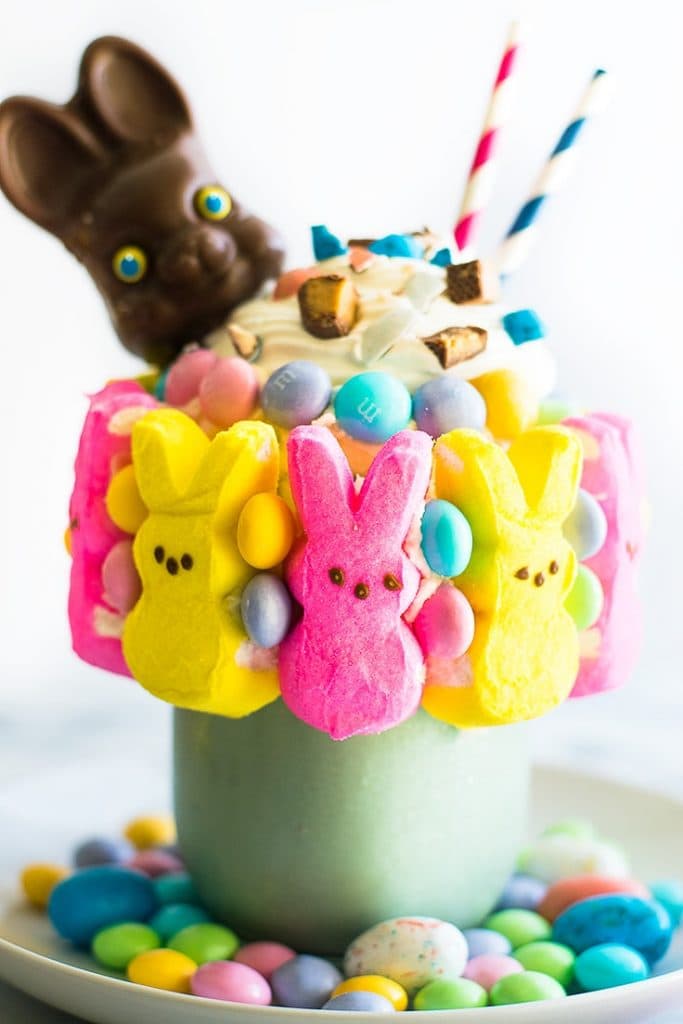 Picture of an Easter Candy Freakshake in a mason jar with candy Peeps stuck to the outside.