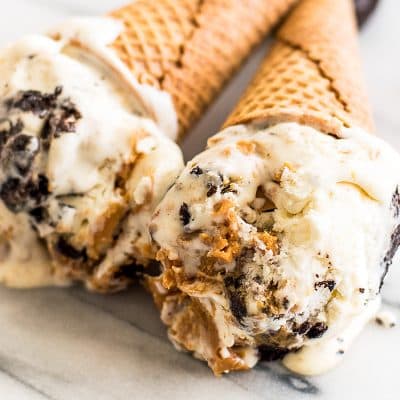 This No-churn Peanut Butter Oreo Ice Cream is creamy homemade vanilla ice cream with swirls of peanut butter, chunks of Oreos, and Reese's Peanut Butter Cups Minis throughout. What could be better?
