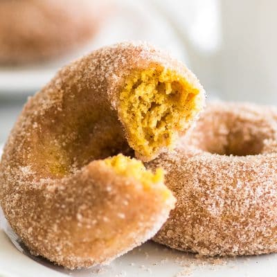 Soft and fluffy baked pumpkin donuts tossed in crunchy cinnamon sugar are the perfect sweet way to celebrate fall mornings. | #Fall | #Breakfast | #Donuts |