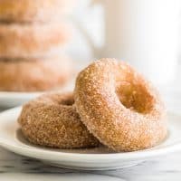 Soft and fluffy baked pumpkin donuts tossed in crunchy cinnamon sugar are the perfect sweet way to celebrate fall mornings. | #Fall | #Breakfast | #Donuts |