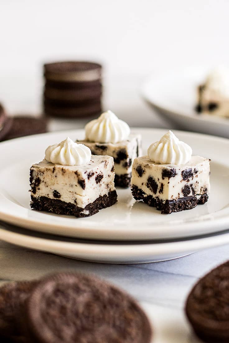 Three oreo cheesecake bites on a plate.
