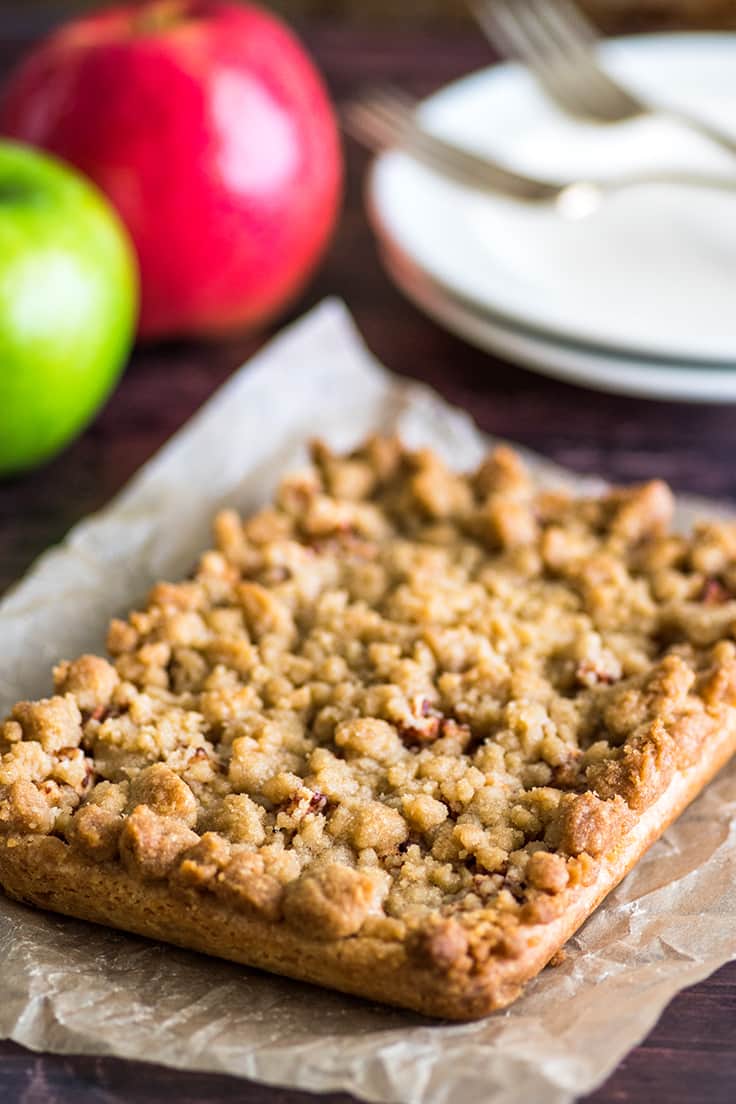 Apple pie bars on parchment paper before cutting.