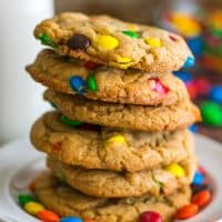 Stack of small-batch M&M Cookies on a white plate.
