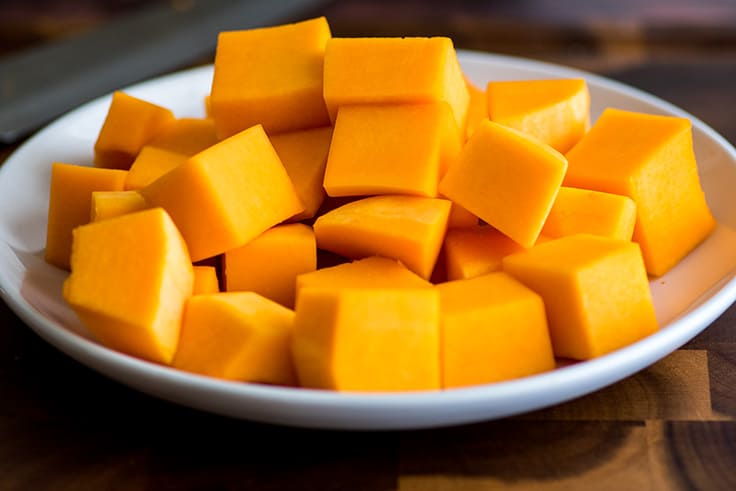 Chopped butternut squash on a plate.
