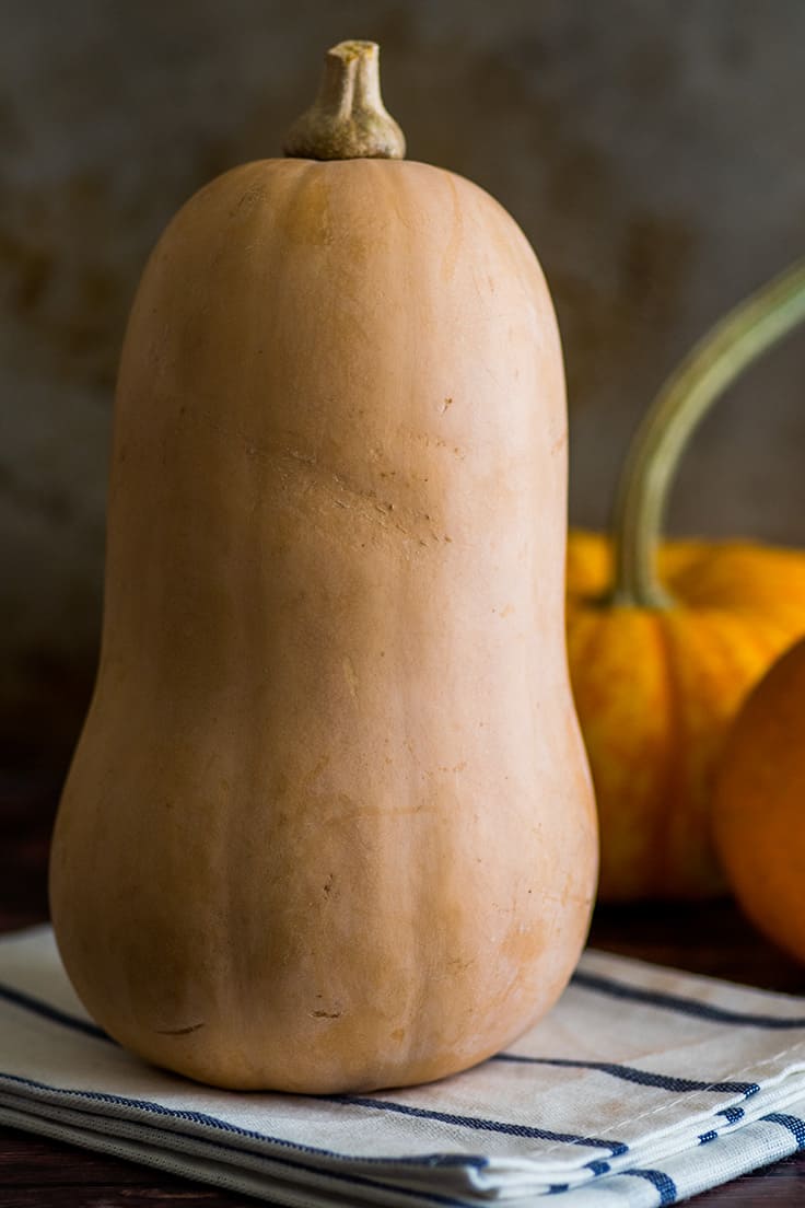Whole butternut squash on a towel.