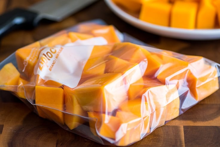 Cut butternut squash in a freezer bag.
