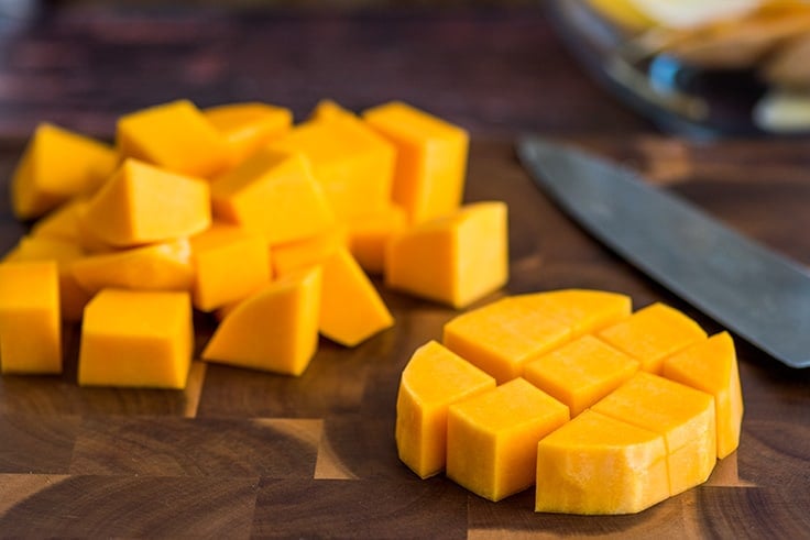 Butternut squash being cut into pieces.