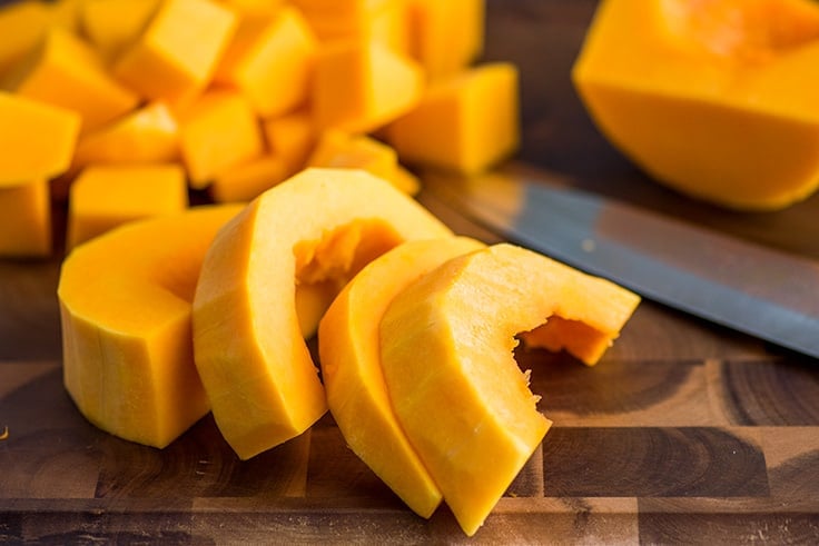 Base of butternut squash being cut.