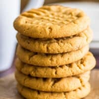 Stack of small-batch peanut butter cookies on parchment paper.