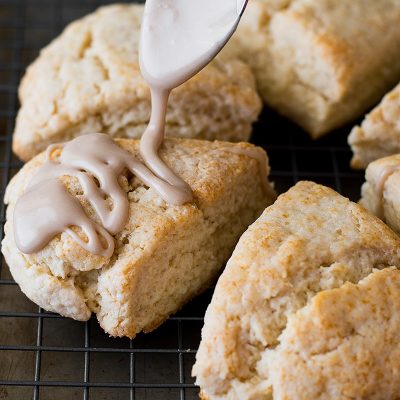 Maple glaze being drizzled over small-batch scones.