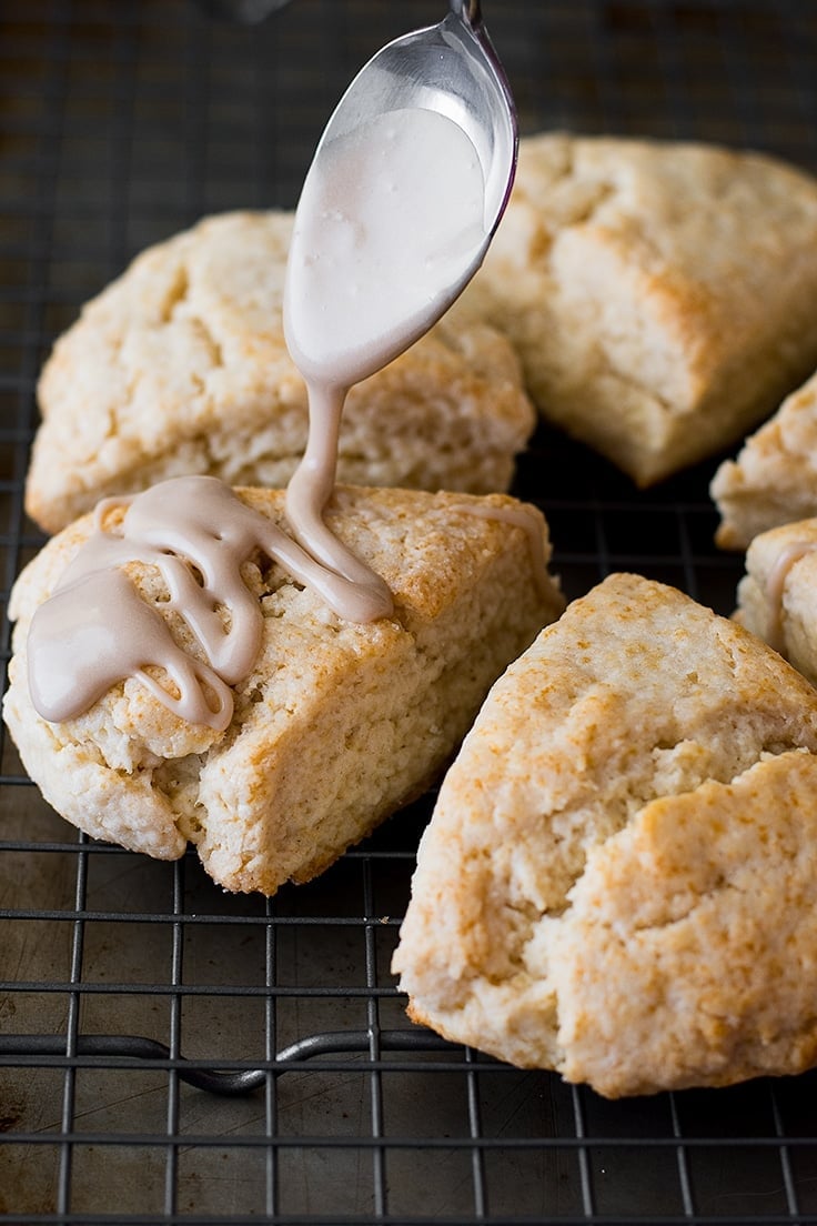 Maple glaze being drizzled over small-batch scones.