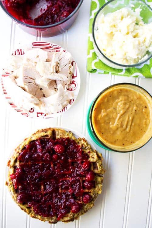Stuffing waffles with toppings on a table top.