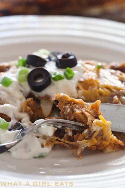 Cheesy Turkey Enchiladas on a white plate.