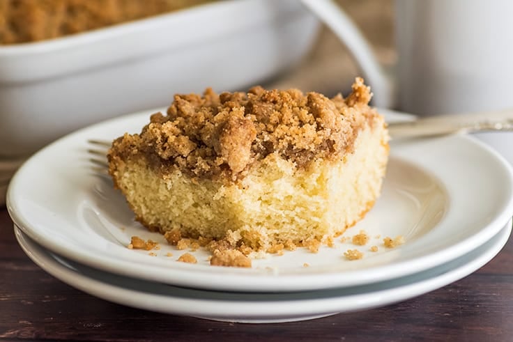 Mini coffee cake slice with a bite out of it.