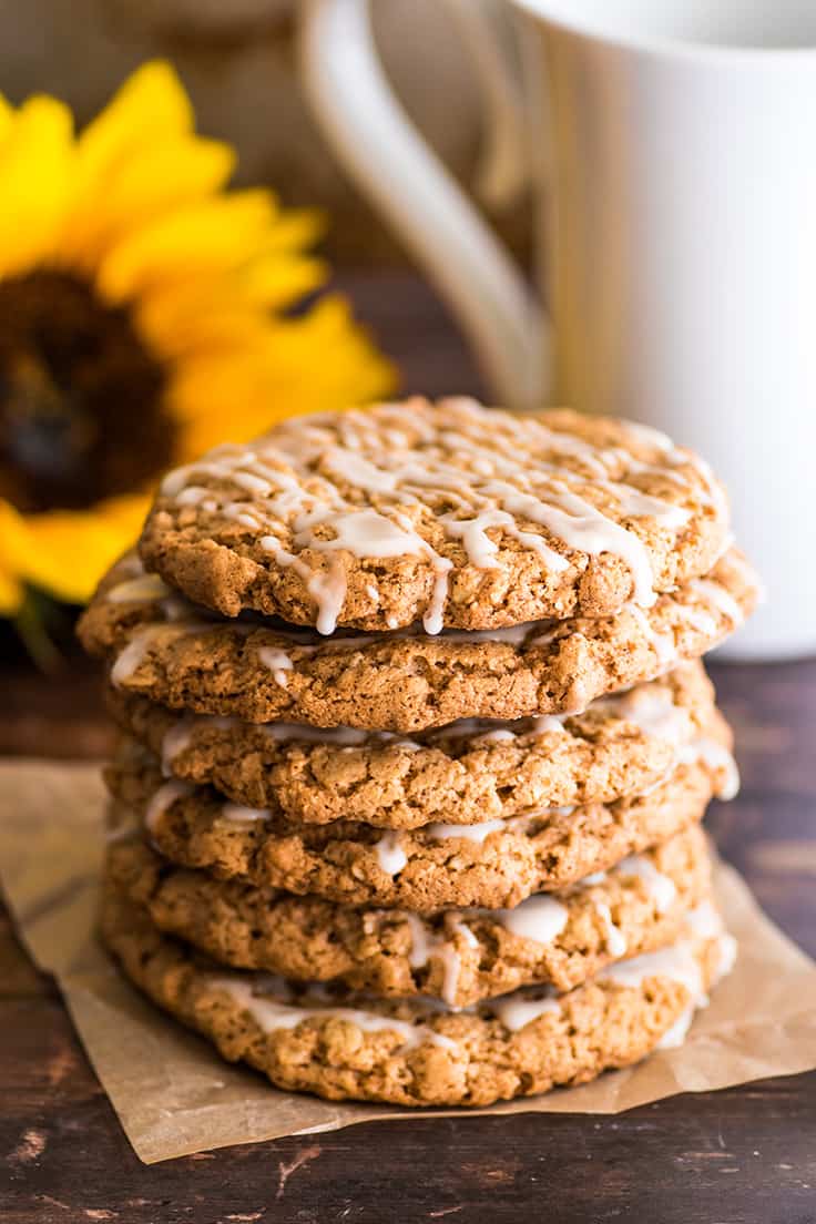 Small batch of oatmeal cookies stacked on parchment paper.