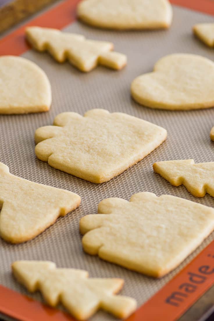 Small batch of sugar cookies cut out and baked on a baking sheet.
