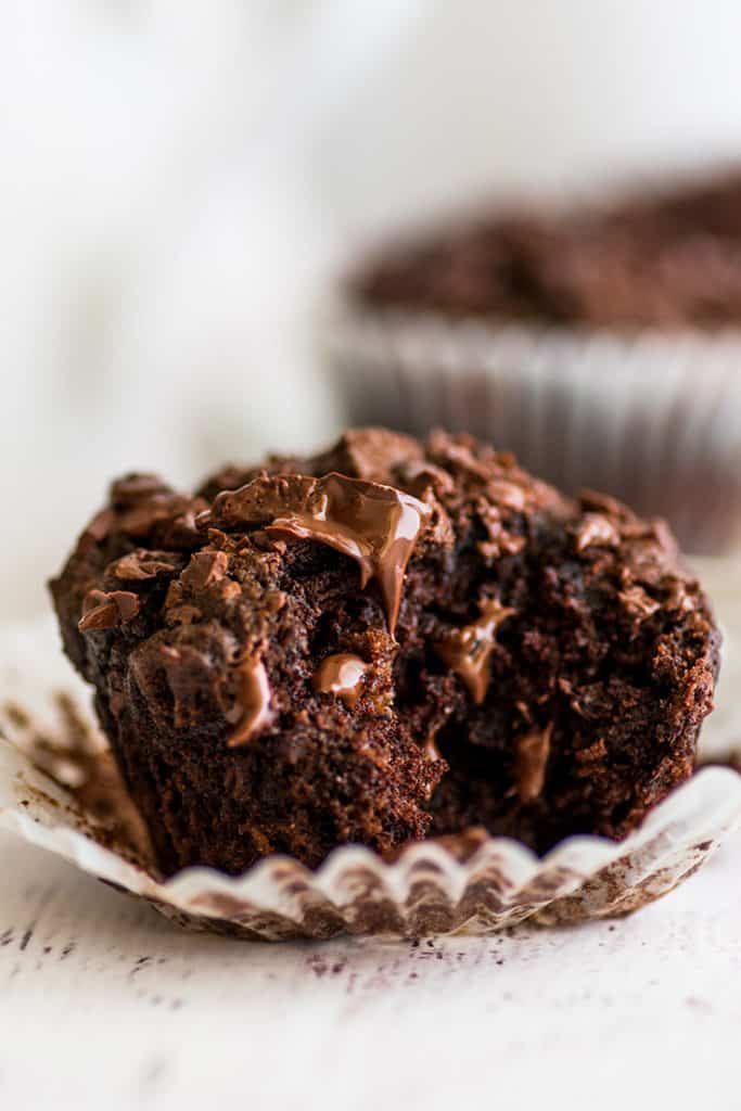 The BEST Chocolate Banana Muffins you'll ever eat. This easy small-batch recipe makes 5 muffins. You just need one ripe banana and one bowl, and you can be pulling these out of your oven in less than half an hour. | #breakfast | #chocolate | #bananamuffins | #breakfastfortwo | Photo of Small-batch Chocolate Banana Muffin with a bite out of it.