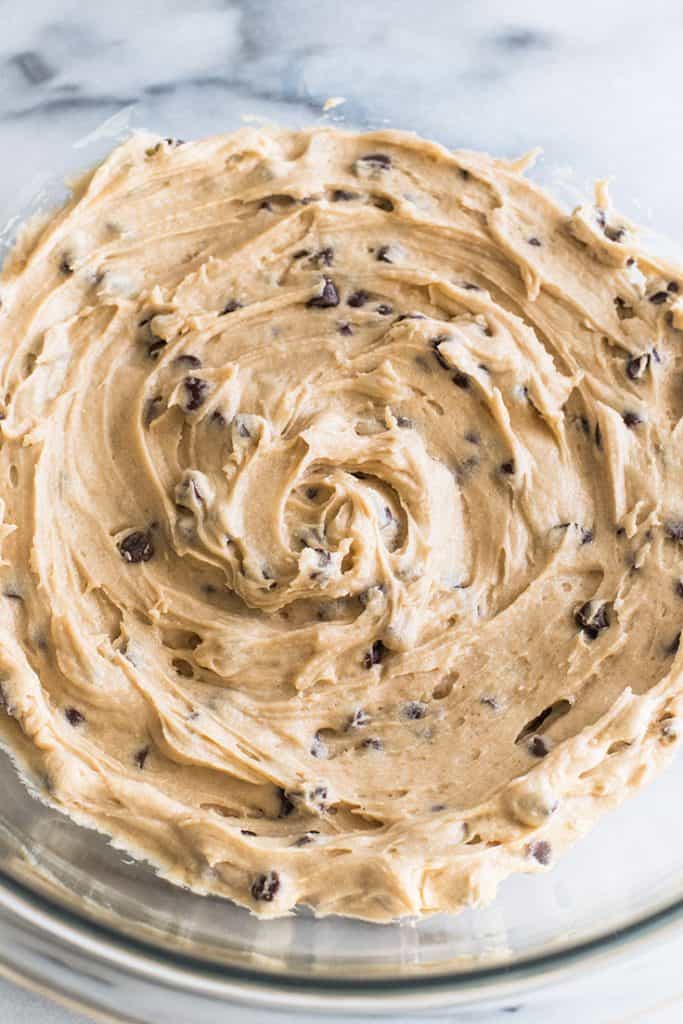 This Small-batch Cookie Dough Frosting tastes just like an extra creamy batch of cookie dough that you happen to get to spread over a cupcake. | #frosting | #cookiedough | #smallbatch | Overhead photo of Small-batch Cookie Dough Frosting in a bowl.