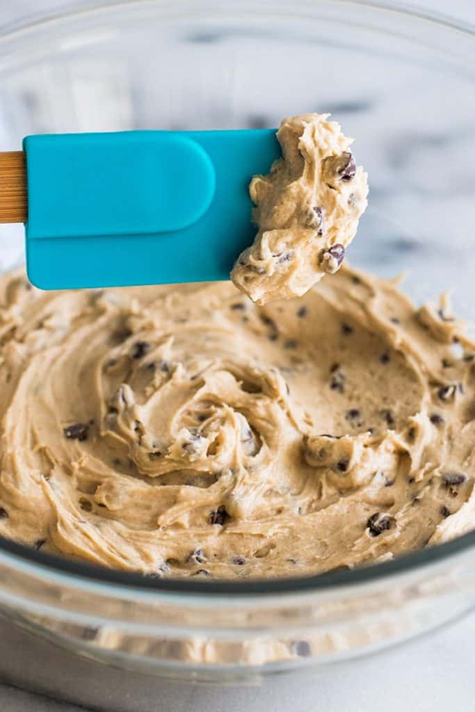 This Small-batch Cookie Dough Frosting tastes just like an extra creamy batch of cookie dough that you happen to get to spread over a cupcake. | #frosting | #cookiedough | #smallbatch | Picture of Small-batch Cookie Dough Frosting on a spoon.