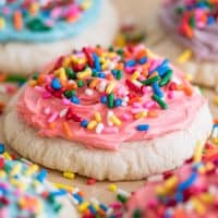 Close photo of Pink Small-batch Frosted Sugar Cookie with rainbow sprinkles.