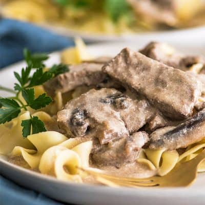 Photo of Easy Beef Stroganoff over egg noodles on a plate.