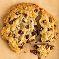 Square photo of One Chocolate Chip Cookie for Two broken into pieces.