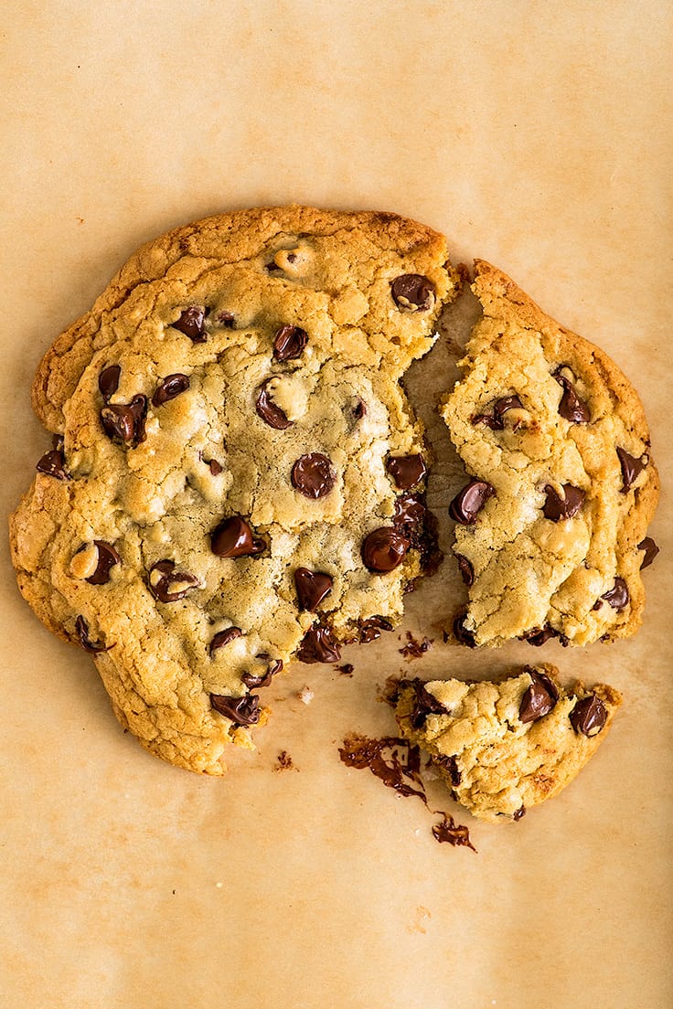 Photo of One Chocolate Chip Cookie for Two broken into pieces.