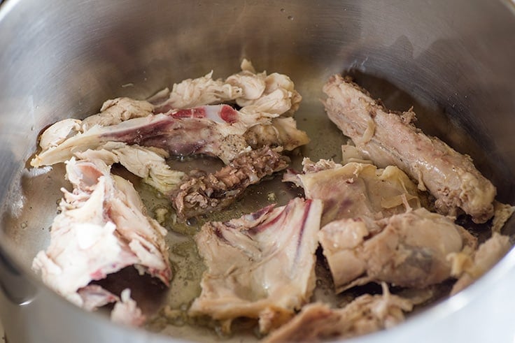 Photo of Chicken Carcass Soup Step 1: cut chicken bones in a pot.