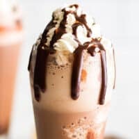 Frozen hot chocolate with whipped cream and chocolate fudge sauce drizzle.
