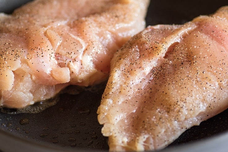 Photo showing how to cook chicken breasts in a pan.