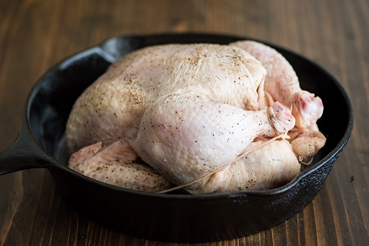 Photo of roasted chicken step 2 raw chicken in cast iron.