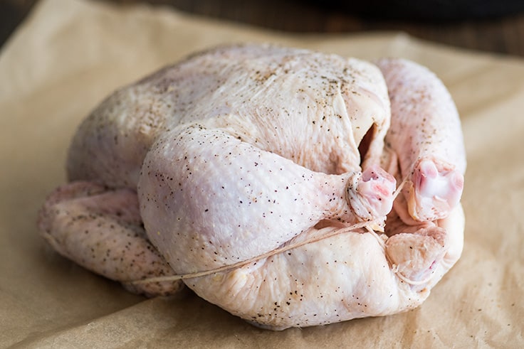 Photo of roasted chicken step 4 raw chicken trussed.