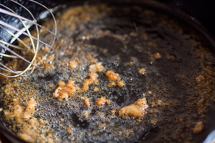 Photo of How to Make Gravy From Drippings step 2: pan drippings being browned on the stove.