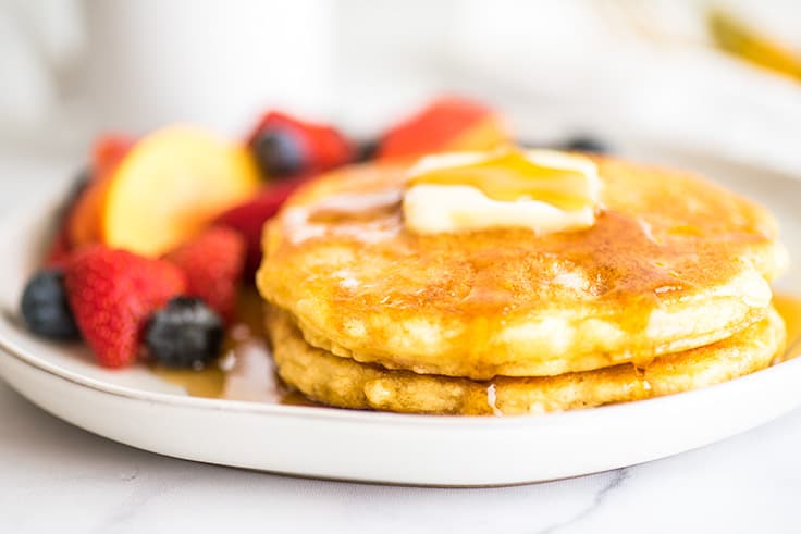 Picture of Quick and Easy Pancakes for One on a white plate with fruit.