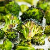 Crispy oven-roasted broccoli on a baking sheet.