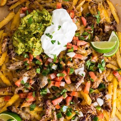 Overhead photo of Carnitas Nacho Fries on parchment paper.