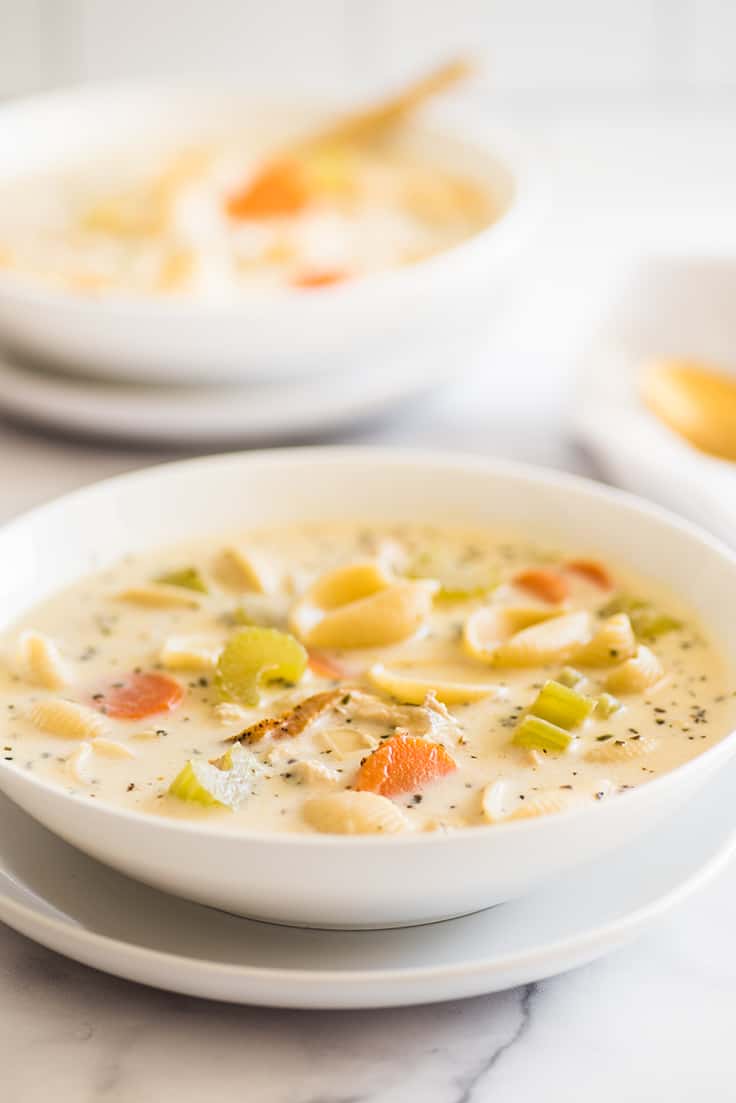Photo of Easy Creamy Chicken Noodle Soup in a white bowl.