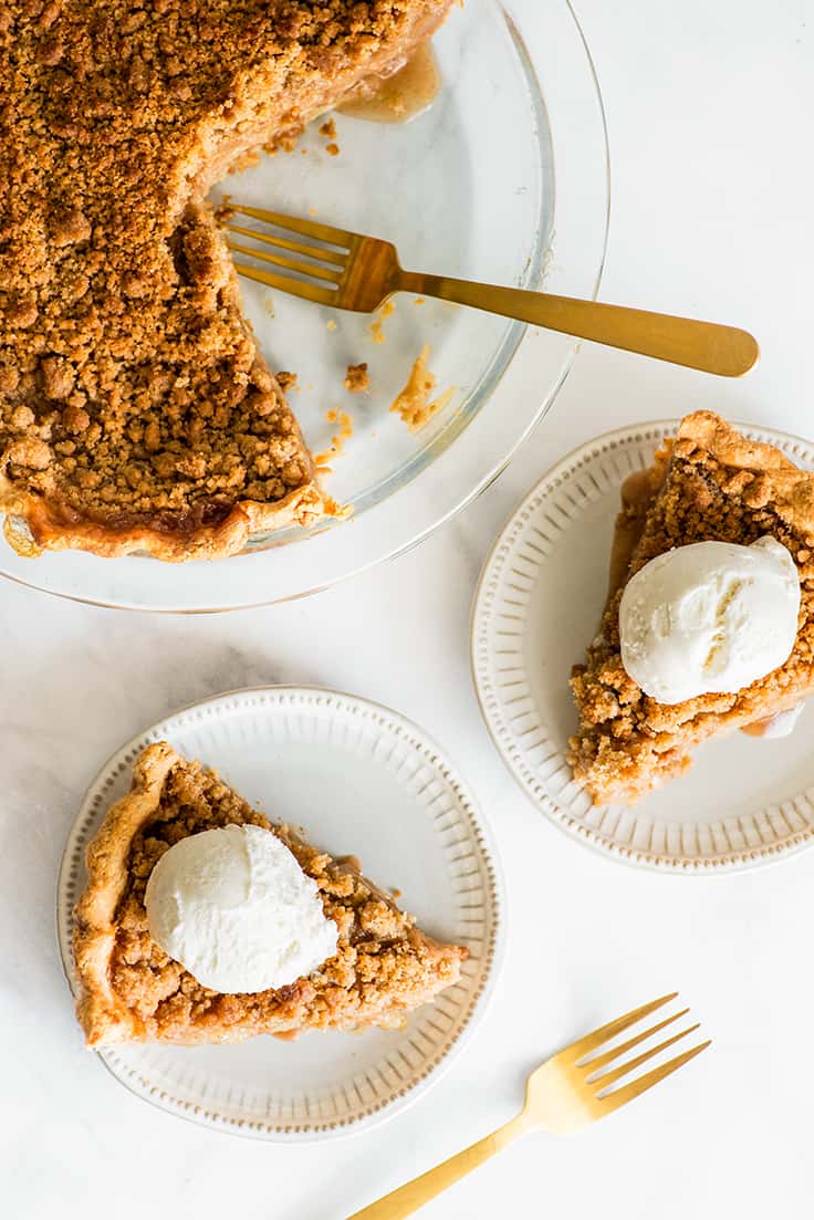 Overhead photo of Dutch Apple Pie cut into slices on white plates.