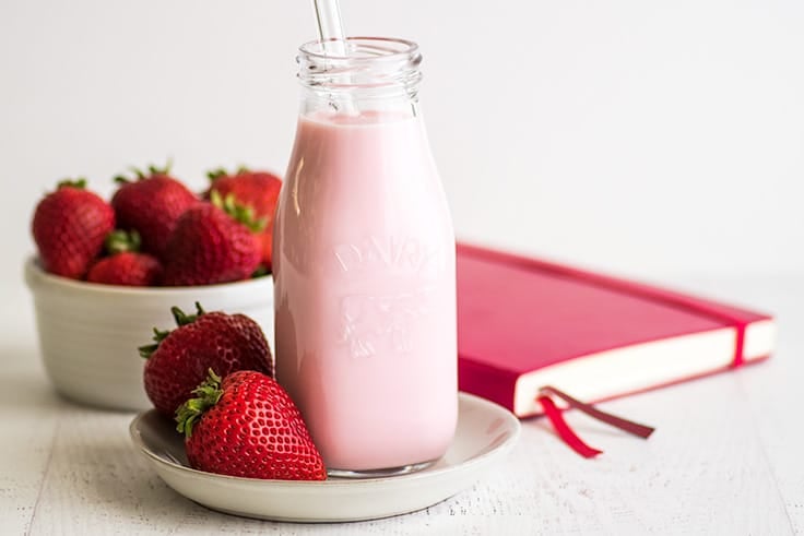 Photo of Homemade Strawberry Milk for One or Two on a plate with strawberries.